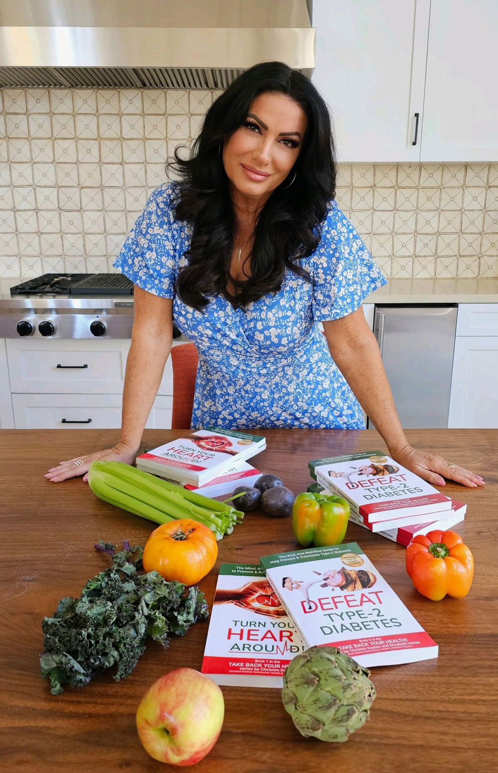 Christen Kaplan in the kitchen with her books and fresh fruit and veggies